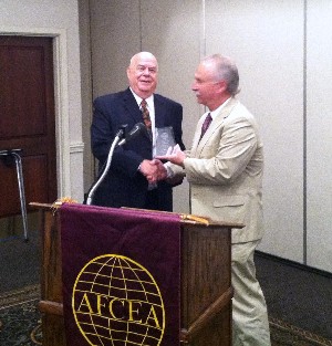 Dr. Bill Craig (l), director of the Software Engineering Directorate, U.S. Army Aviation and Missile Research, Development and Engineering Center, accepts a token of appreciation from Michael Schexnayder, chapter vice president for programs.